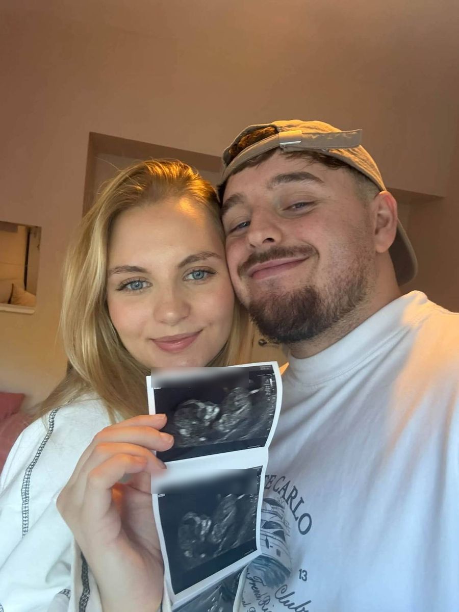 Lucy and partner holding the first scan photo